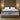 Front-facing view of the Springfit Autograph Prive mattress with a distinctive grey tufted pillow top and white striped border, displayed on a grey platform bed in a warm-lit bedroom with slatted wood wall panelling