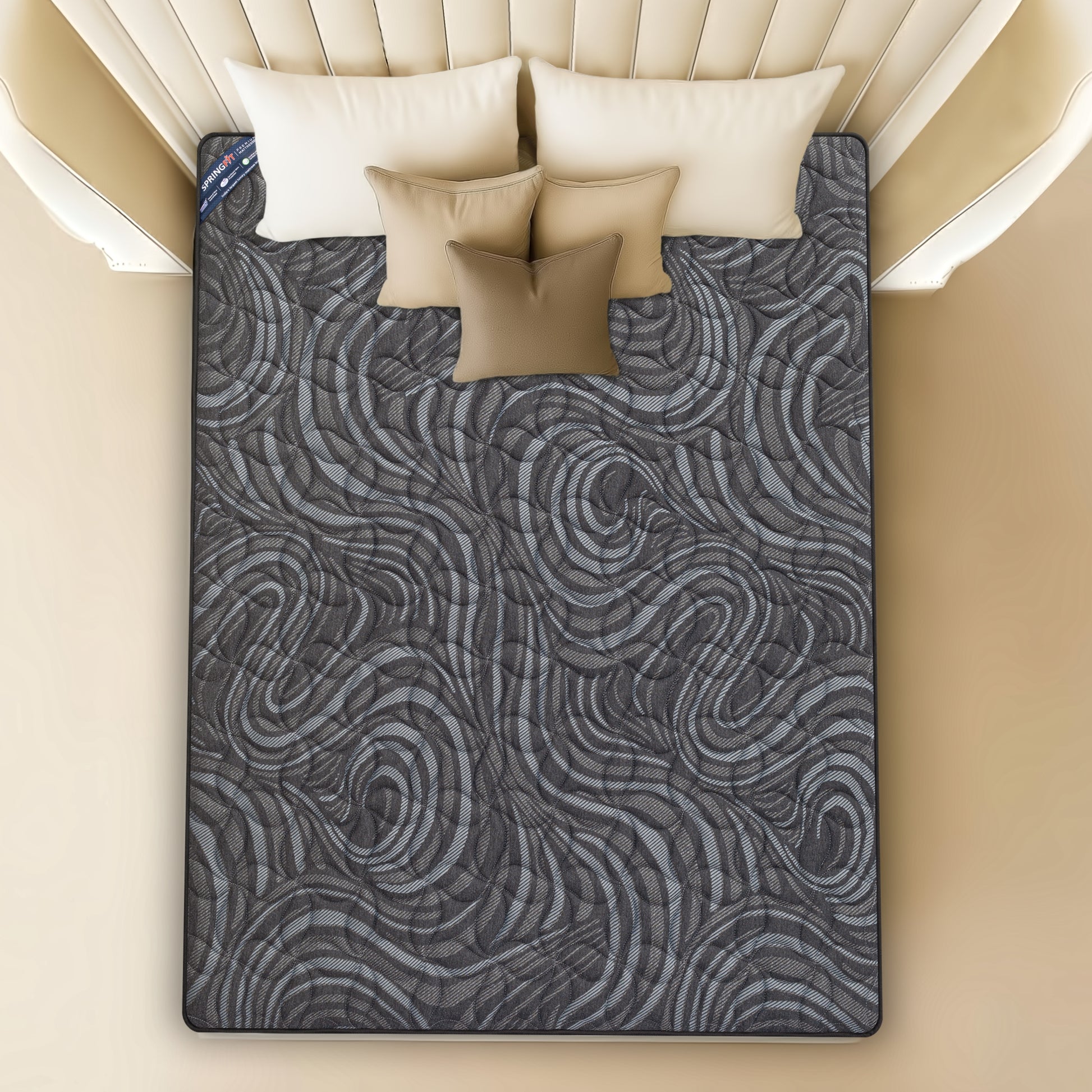 Top-down view of Springfit BetterSpine Elevate mattress showing distinctive dark swirl-pattern knitted fabric surface with beige pillows