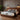 Springfit Club Class Grande mattress on walnut platform bed with grey and white pillows in warm industrial-style bedroom with concrete panel wall, black wall sconces, indoor plant, and herringbone floor