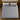 Springfit Club Class Petals mattress aerial top view showing grey diamond-quilted knitted fabric with black border on wooden bed frame with white and grey pillows