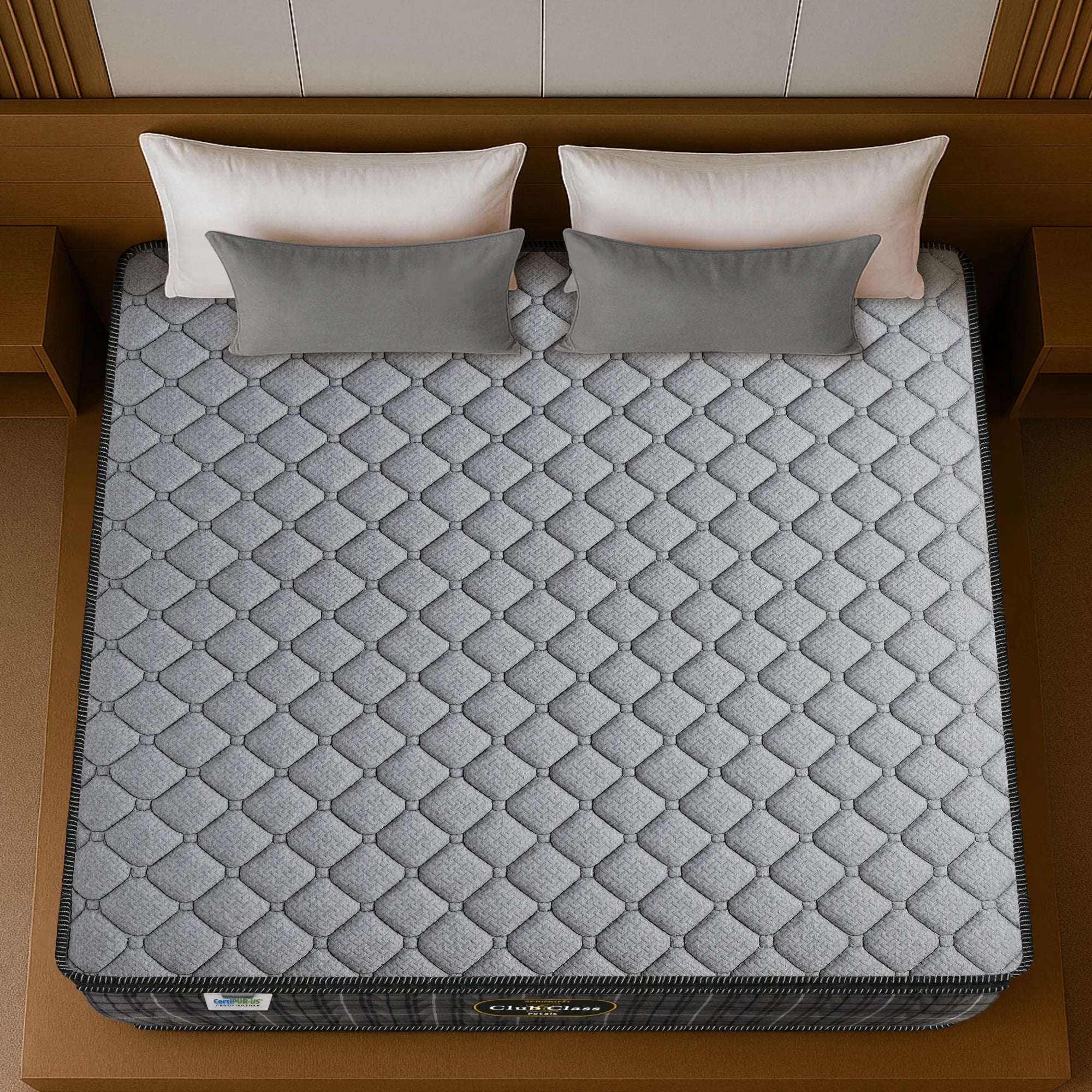 Springfit Club Class Petals mattress aerial top view showing grey diamond-quilted knitted fabric with black border on wooden bed frame with white and grey pillows
