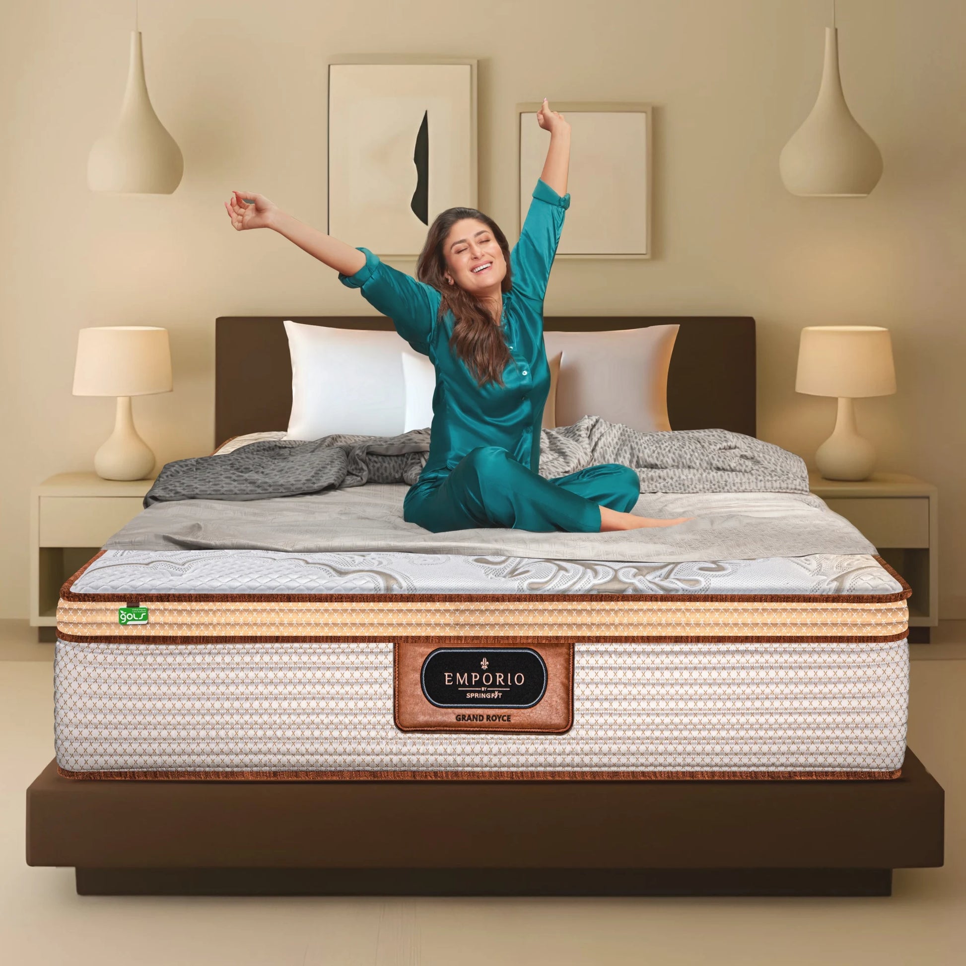 Springfit Emporio Grand Royce mattress with GOLS certification on a dark bed frame with brand ambassador stretching joyfully in a warm luxury bedroom