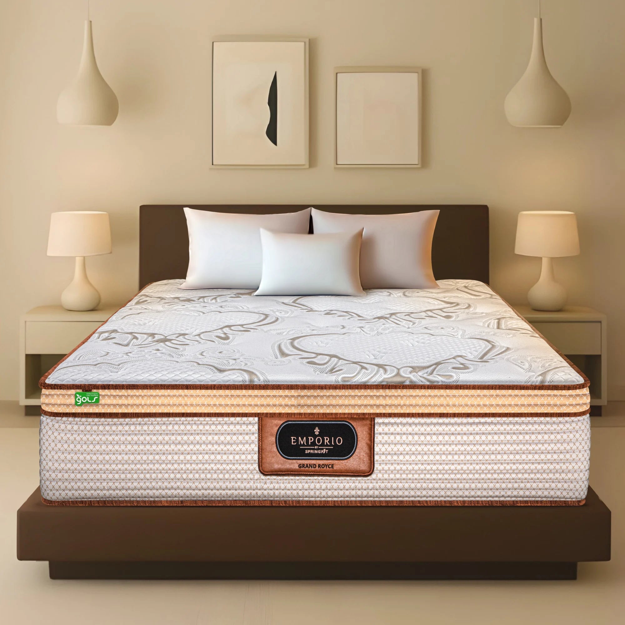 Front view of Springfit Emporio Grand Royce mattress with ornate white and gold fabric top on dark platform bed with white pillows in a warm beige bedroom