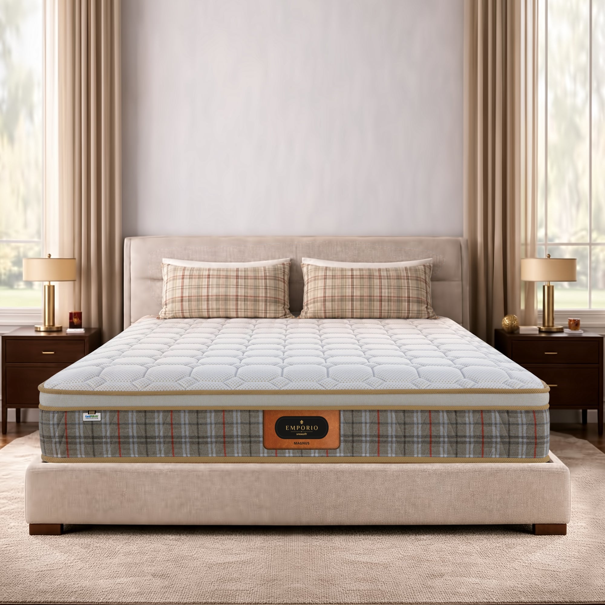 Front-facing view of the Springfit Emporio Magnus mattress with a white quilted top and tartan fabric border, displayed on a beige upholstered king bed in an elegant bedroom with gold table lamps and matching plaid pillowcases

