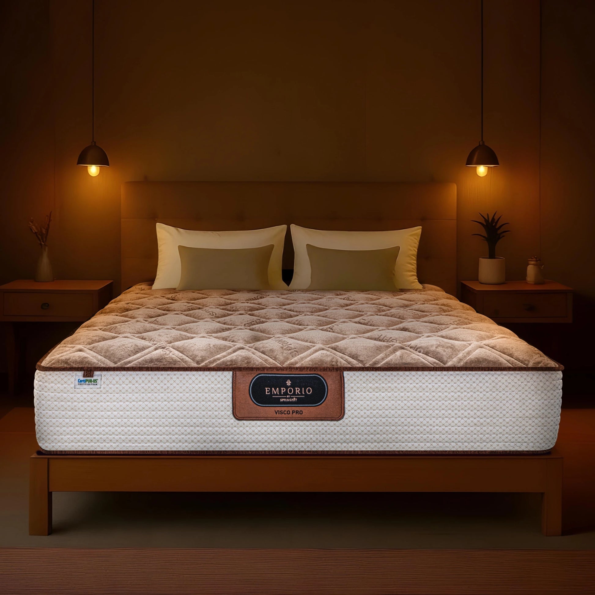 Front-facing view of the Springfit Emporio Visco Pro mattress with a brown velour diamond-quilted pillow top and white quilted base, displayed on a wooden bed in a warm amber bedroom with matching pendant lamps and gold-toned pillows