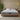 Front-facing view of the Springfit iSleep Blue mattress with a white diamond-quilted top and grey patterned fabric border, placed on a low natural wood platform bed in a warm boho bedroom with textured plaster walls and indoor plants