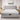 Front-facing view of the Springfit iSleep Ortho mattress on a grey tufted upholstered bed in a bright, minimalist white bedroom with matching nightstands and lamps