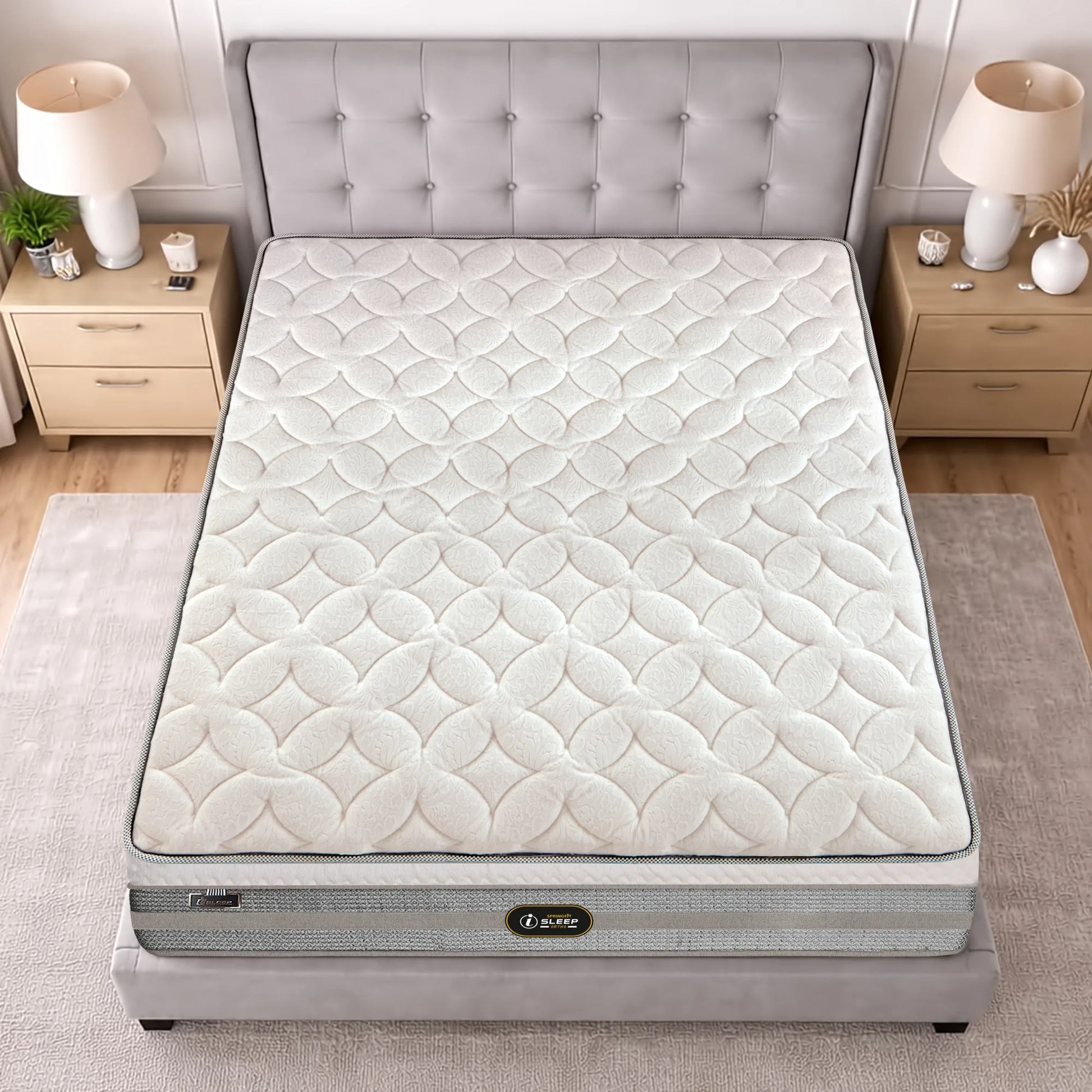 Bird's-eye top view of the Springfit iSleep Ortho mattress showing its full scallop-patterned quilted surface on a grey upholstered bed with flanking nightstands