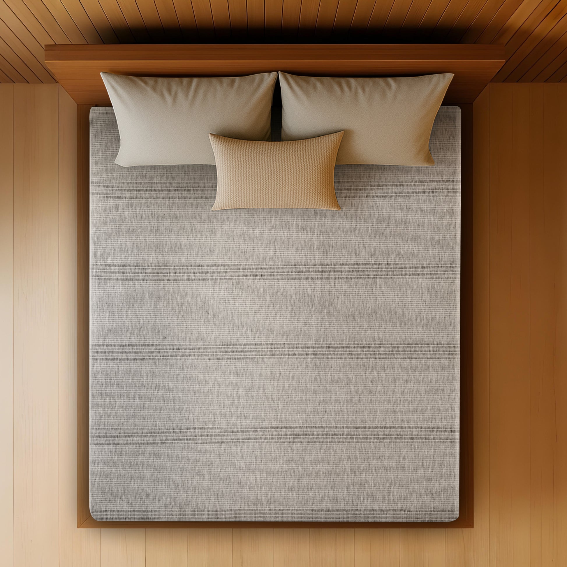 Overhead top-down view of the Springfit Memory Foam mattress showing its full grey striped melange knitted fabric surface on a wooden platform bed with two grey and one ochre accent pillow, set against a warm wood-panelled ceiling