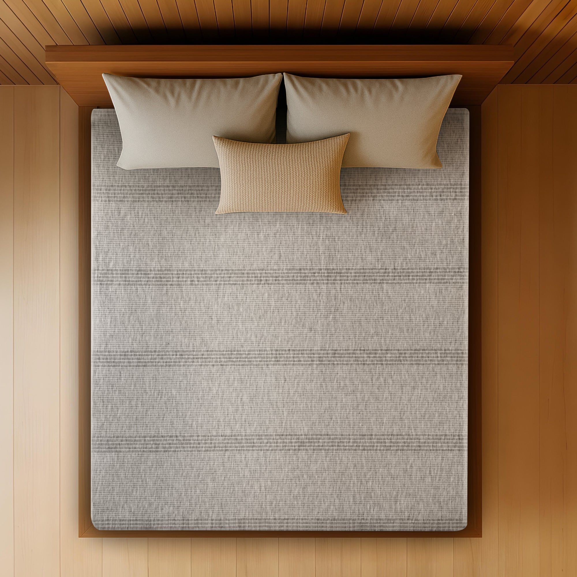 Overhead top-down view of the Springfit Memory Foam mattress showing its full grey striped melange knitted fabric surface on a wooden platform bed with two grey and one ochre accent pillow, set against a warm wood-panelled ceiling