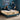 Springfit ProActiv Back mattress with couple in matching navy nightwear in teal accent bedroom with wooden nightstands and warm lamp lighting