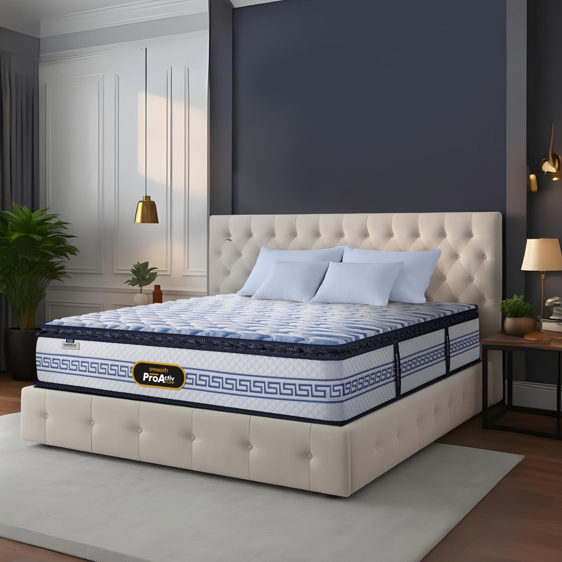 Springfit ProActiv Flow mattress on beige tufted platform bed in elegant navy and white bedroom with gold pendant lights, light blue pillows, and decorative plants