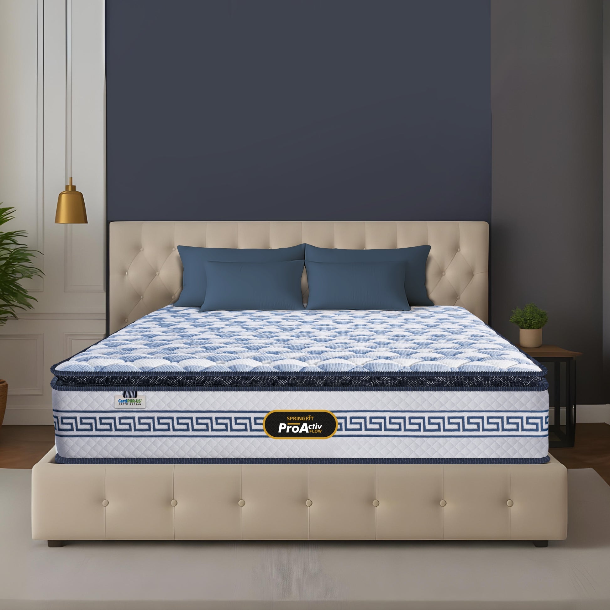 Springfit ProActiv Flow mattress on beige tufted upholstered bed with dark teal cushions in blue-grey accent bedroom with gold pendant light and indoor plants