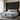 Angled side view of the Springfit Reactive Classic mattress with a white quilted pillow top and grey wave-patterned fabric border, on a beige upholstered platform bed in a luxury bedroom with a dramatic dark grey channelled headboard, sheer curtains, and table lamps