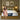 Springfit Reactive Dual Latex mattress on a wooden platform bed in an olive-green toned bedroom with globe pendant wall lamps and abstract wall art, with a brand ambassador in a pink floral dress seated on the mattress edge
