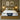 Front-facing view of the Springfit Reactive Dual Latex mattress with a white branded quilted top and navy piping, placed on a wooden platform bed in an olive-green bedroom with globe pendant lamps, olive cushions, and abstract wall art