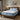 Springfit Reactive Dual mattress on solid wooden bed frame with light blue pillows in warmly lit Scandinavian-style bedroom with pendant light and potted plant