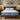 Springfit Reactive Dual mattress on solid wooden bed with light blue pillows in neutral-toned bedroom with twin pendant lights and matching wooden nightstands