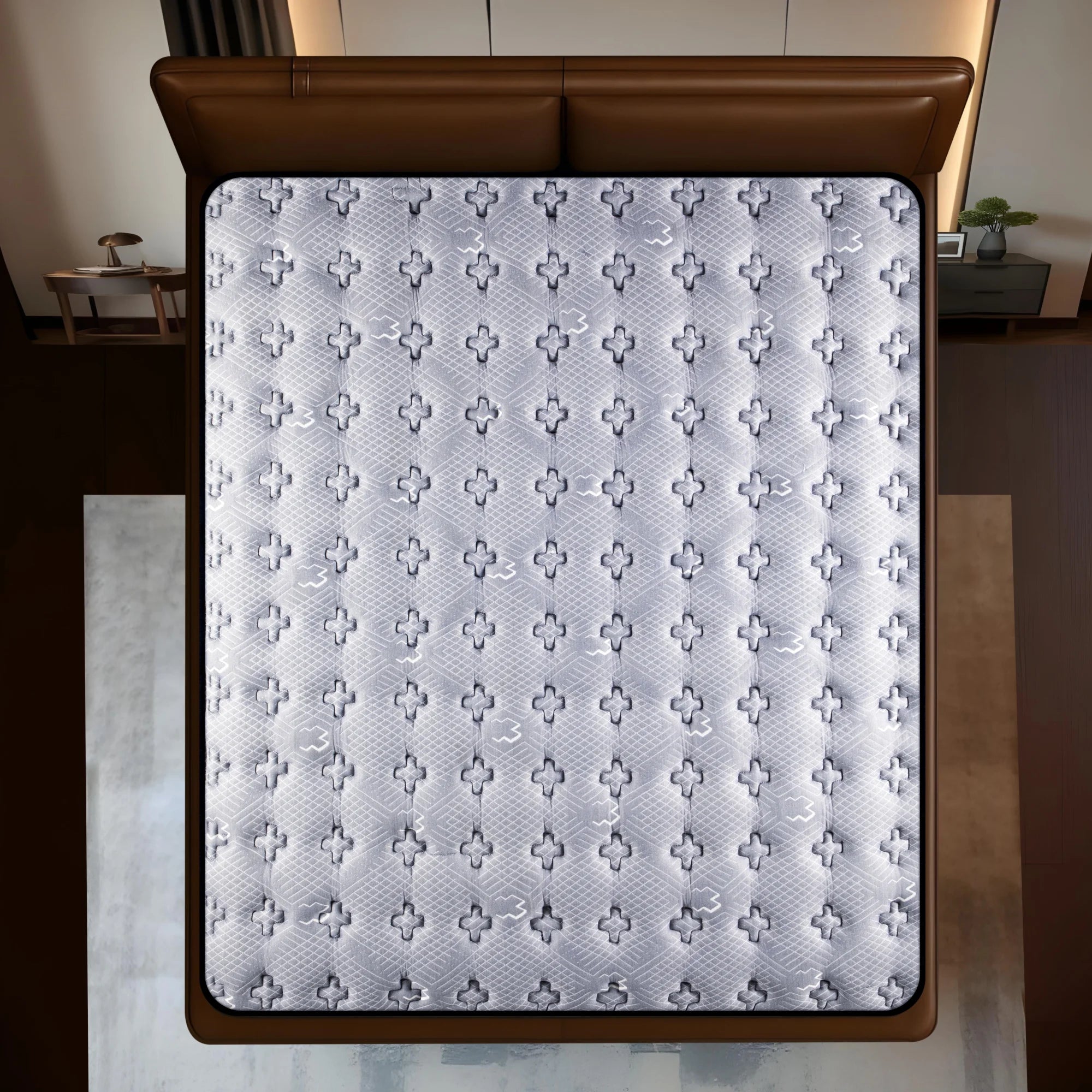 Springfit Reactive Ortho mattress aerial top view showing grey and white cross-pattern breathable knitted fabric on brown leather bed with matching nightstands