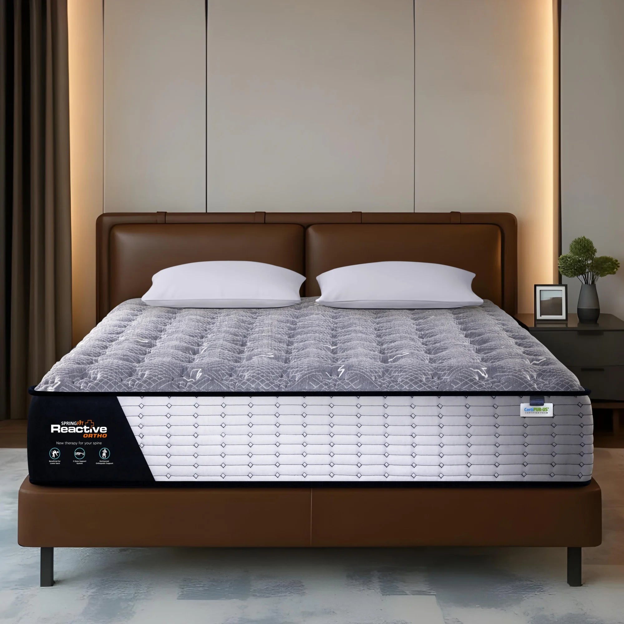 Springfit Reactive Ortho mattress on brown leather bed with two white pillows in warm neutral-toned bedroom with backlit panel wall, indoor plant, and dark grey nightstand