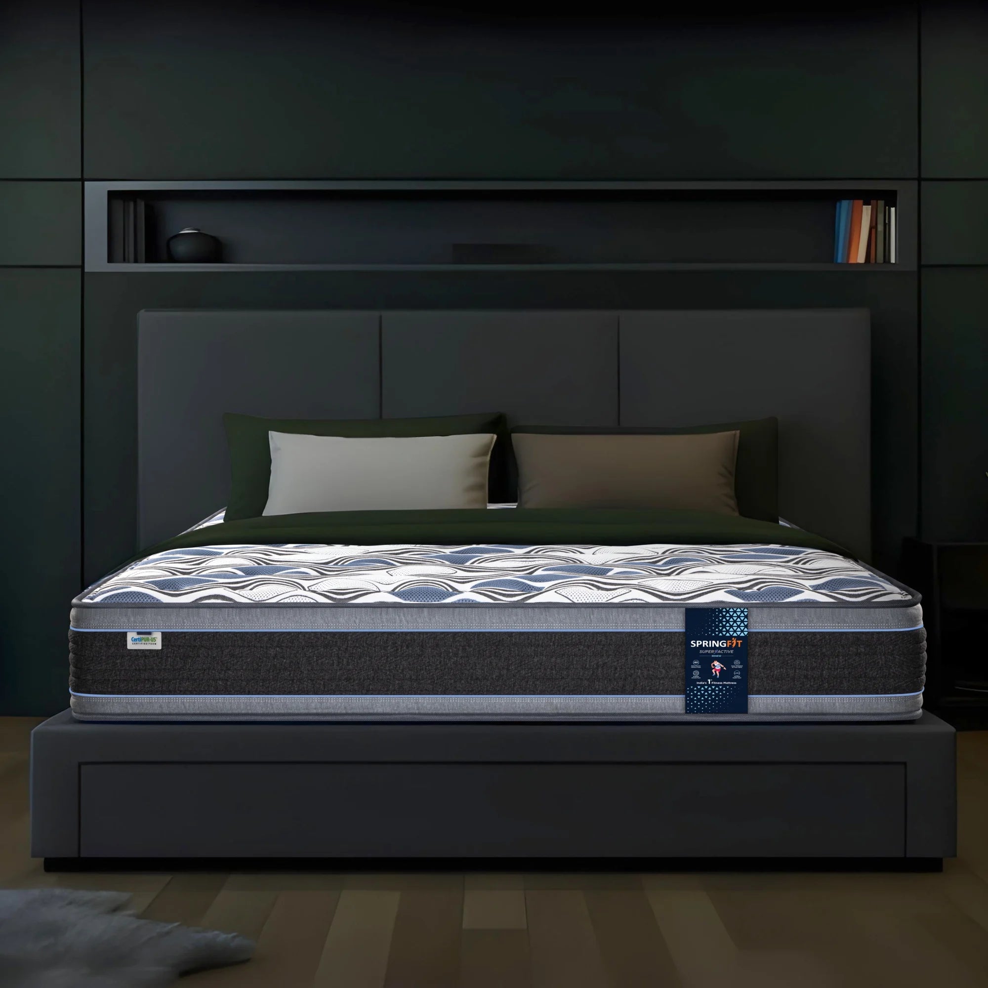 Front view of Springfit Super Active Renew mattress with distinctive blue and white wave-pattern top on a dark platform bed with olive green pillows