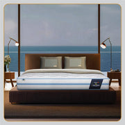 Springfit Wellness Orthopedic mattress placed on a dark wooden bed frame in a luxurious bedroom with a panoramic ocean view and warm floor lamps