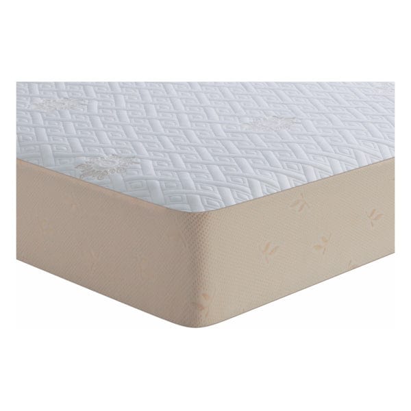 Close-up corner detail of Springfit mattress protector showing white quilted diamond-pattern top surface and snug-fitted beige elastic skirt on mattress