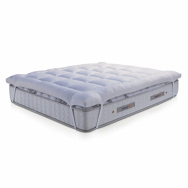 Side elevation view of Springfit mattress topper highlighting plush loft and fill thickness with white tufted top and flat base on white background