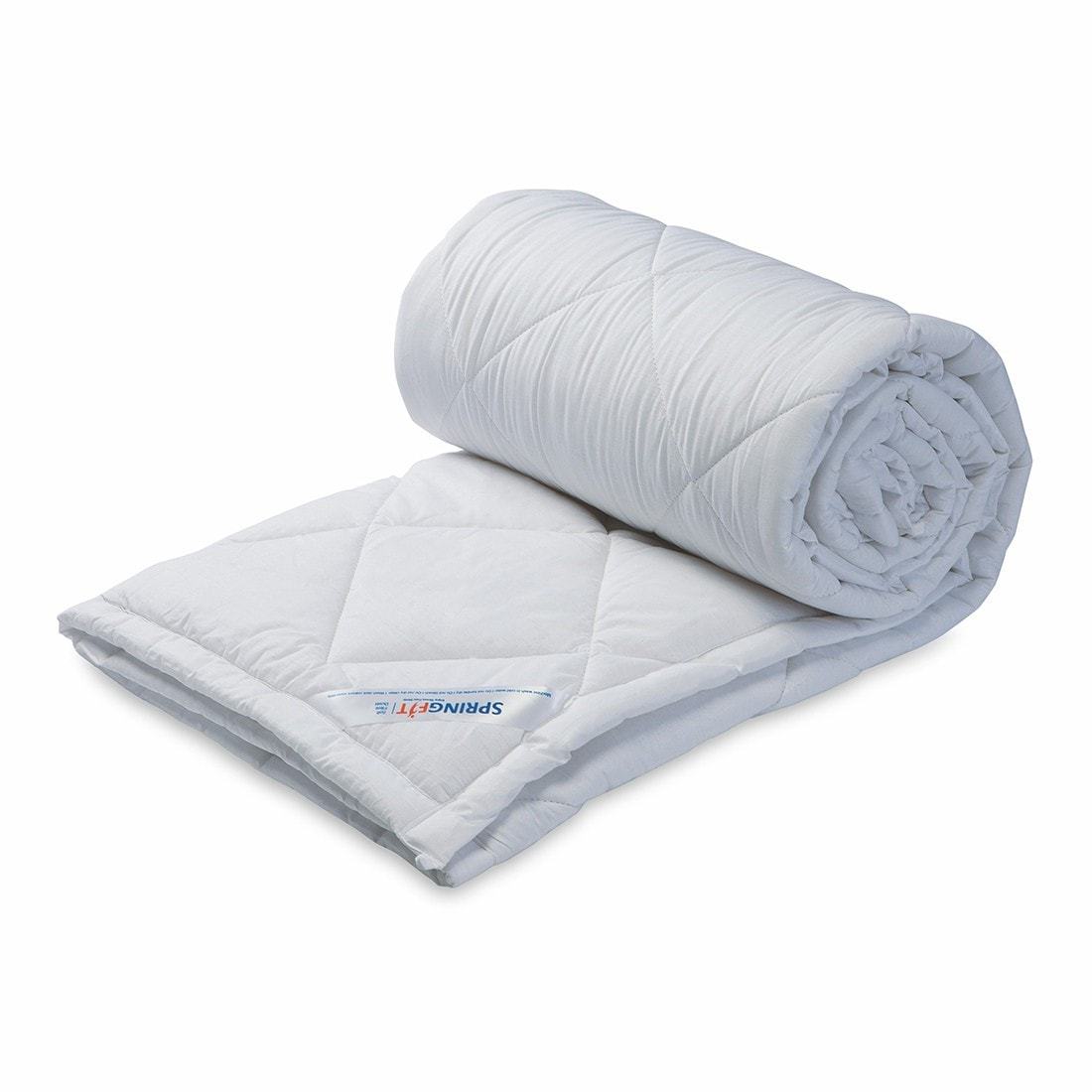 Springfit Premium Quilt in white with diamond quilting pattern, shown rolled up compactly for storage on white background