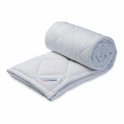 Springfit Premium Quilt in white with diamond quilting pattern, shown rolled up compactly for storage on white background